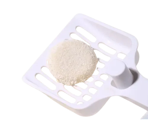 Clumped Cassava Cat Litter on White Plastic Scoop