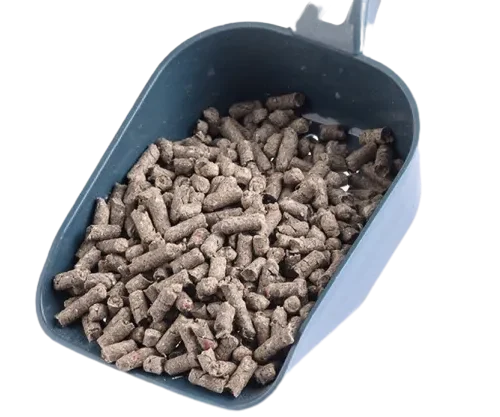 Hand Holding Blue Scoop Filled with Brown Paper Litter