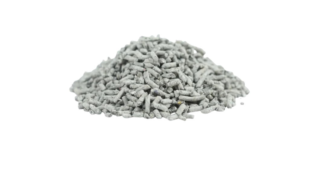Pile of recycled newspaper cat litter pellets on black background