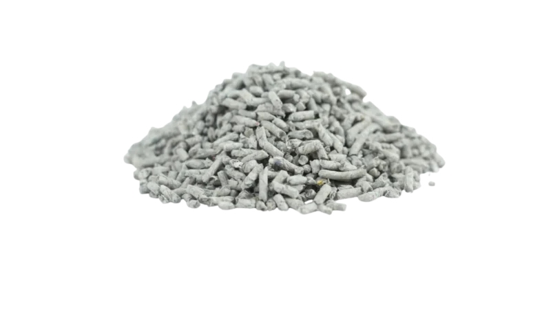 Pile of recycled newspaper cat litter pellets on black background