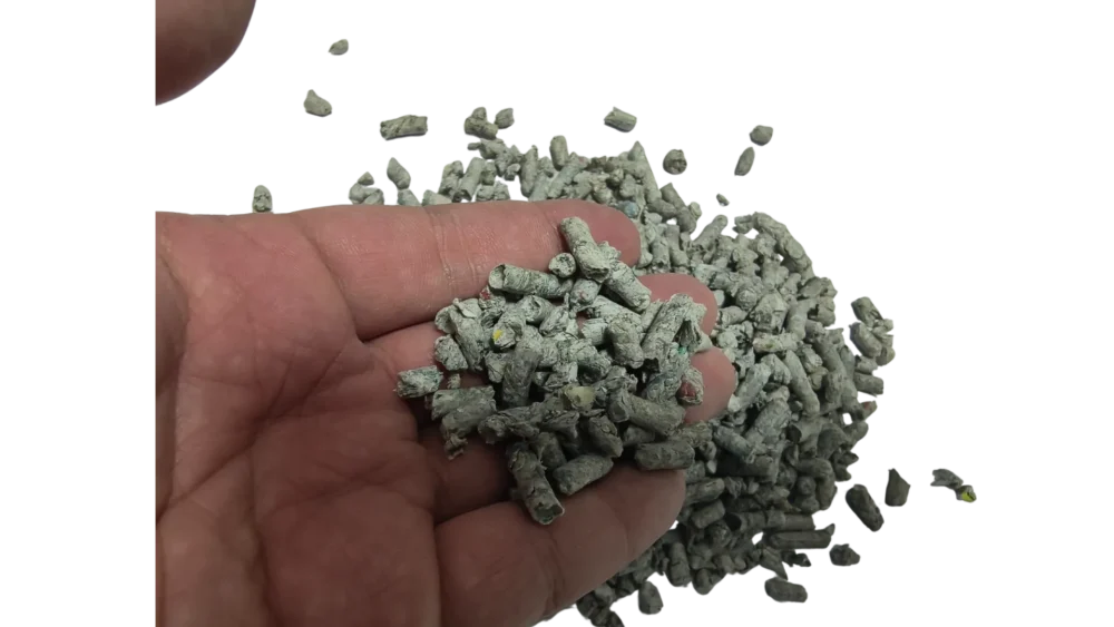 Recycled Newspaper Cat Litter Pellets Pouring from Hand