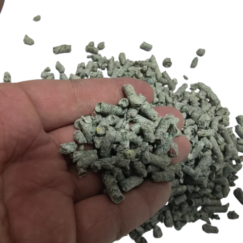 Recycled Newspaper Cat Litter Pellets Pouring from Hand